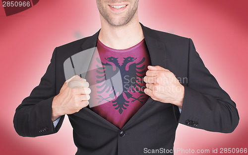 Image of Businessman opening suit to reveal shirt with flag