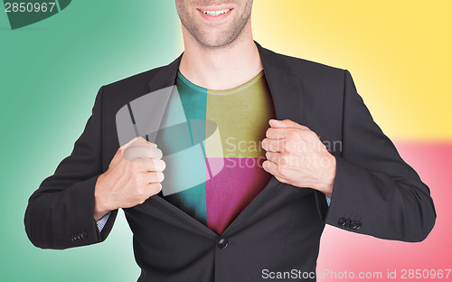 Image of Businessman opening suit to reveal shirt with flag