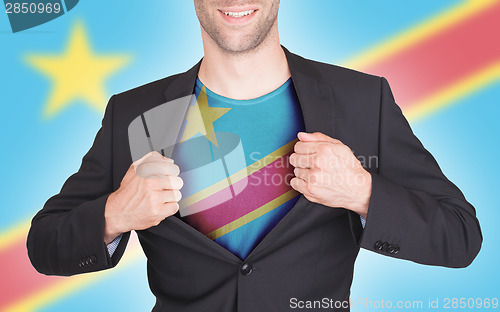 Image of Businessman opening suit to reveal shirt with flag