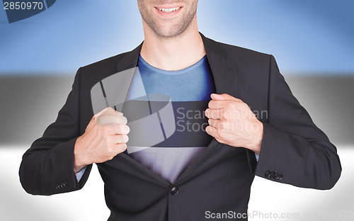 Image of Businessman opening suit to reveal shirt with flag