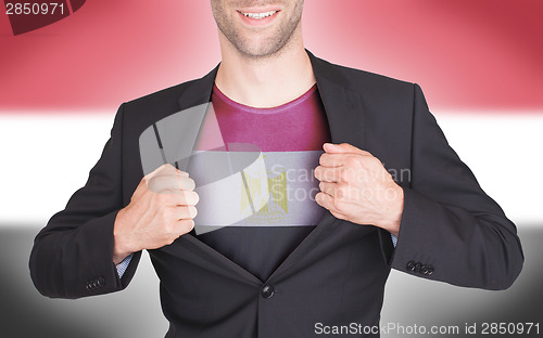 Image of Businessman opening suit to reveal shirt with flag