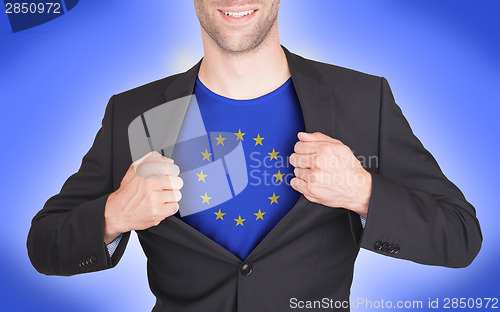 Image of Businessman opening suit to reveal shirt with flag