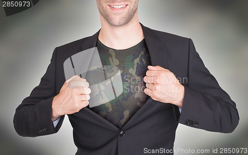 Image of Businessman opening suit to reveal shirt