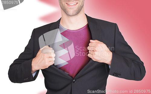 Image of Businessman opening suit to reveal shirt with flag