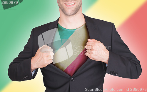 Image of Businessman opening suit to reveal shirt with flag