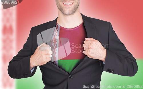 Image of Businessman opening suit to reveal shirt with flag