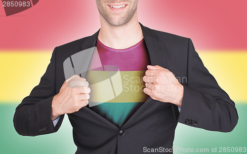 Image of Businessman opening suit to reveal shirt with flag