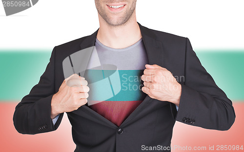 Image of Businessman opening suit to reveal shirt with flag