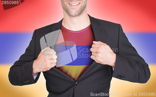 Image of Businessman opening suit to reveal shirt with flag