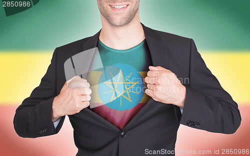 Image of Businessman opening suit to reveal shirt with flag