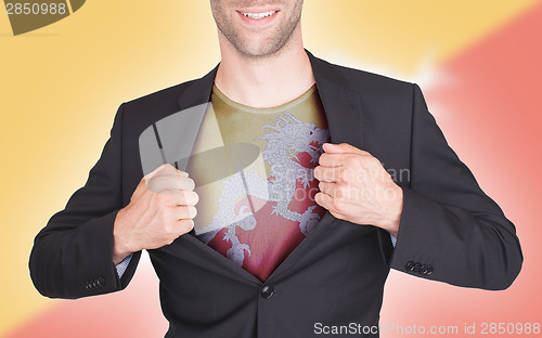 Image of Businessman opening suit to reveal shirt with flag