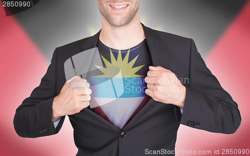 Image of Businessman opening suit to reveal shirt with flag