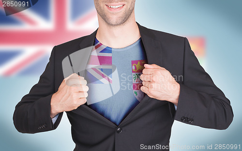 Image of Businessman opening suit to reveal shirt with flag