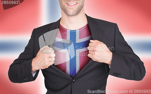 Image of Businessman opening suit to reveal shirt with flag