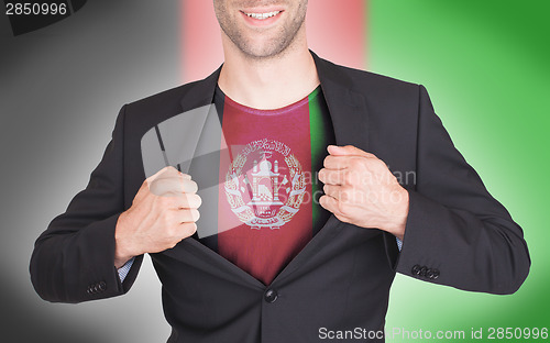 Image of Businessman opening suit to reveal shirt with flag