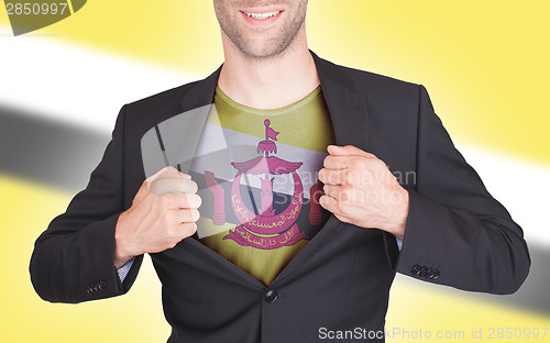 Image of Businessman opening suit to reveal shirt with flag