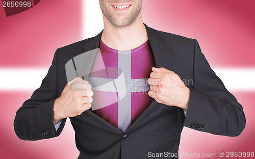 Image of Businessman opening suit to reveal shirt with flag