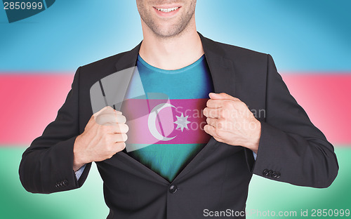 Image of Businessman opening suit to reveal shirt with flag