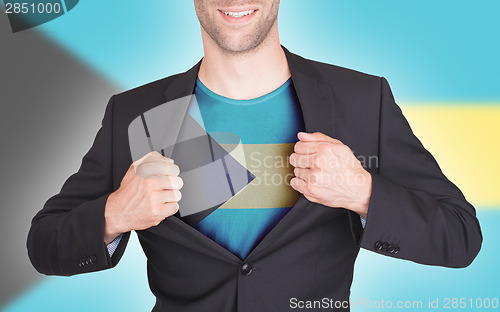 Image of Businessman opening suit to reveal shirt with flag