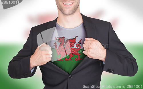 Image of Businessman opening suit to reveal shirt with flag