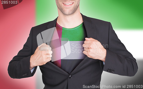 Image of Businessman opening suit to reveal shirt with flag