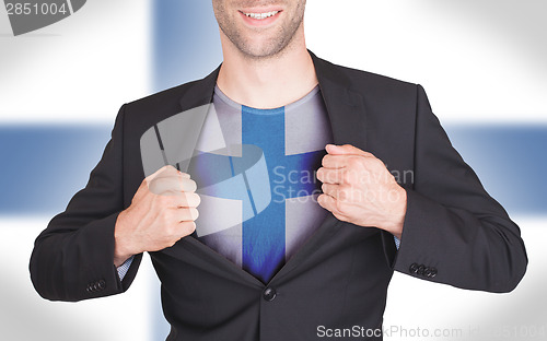 Image of Businessman opening suit to reveal shirt with flag