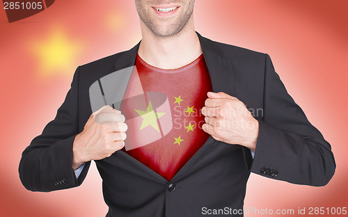 Image of Businessman opening suit to reveal shirt with flag