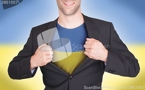 Image of Businessman opening suit to reveal shirt with flag