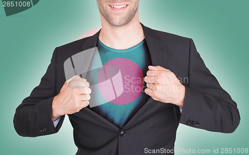 Image of Businessman opening suit to reveal shirt with flag