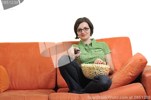 Image of young woman eat popcorn and watching tv