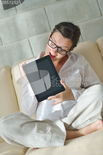 Image of woman using tablet pc at home