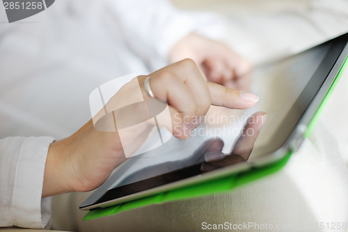 Image of woman using tablet pc at home