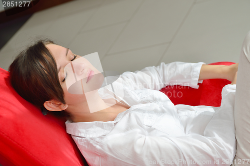 Image of happy young woman relax at home on sofa