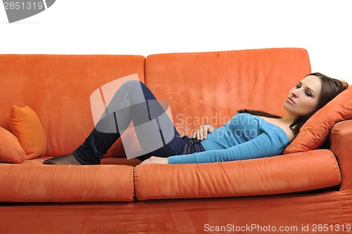 Image of happy young woman relax on orange sofa
