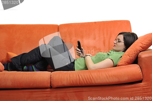 Image of happy young woman relax on orange sofa