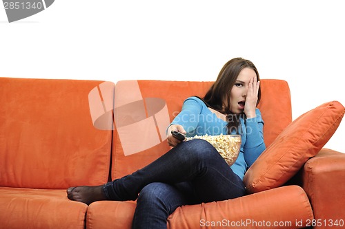 Image of young woman eat popcorn and watching tv