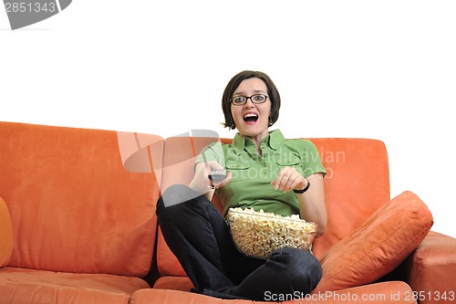 Image of young woman eat popcorn and watching tv