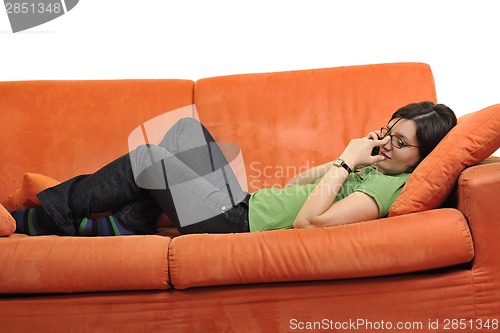 Image of happy young woman relax on orange sofa