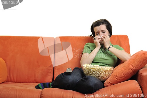 Image of young woman eat popcorn and watching tv