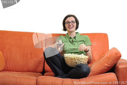 Image of young woman eat popcorn and watching tv