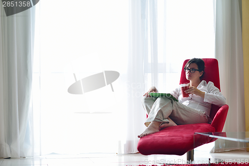 Image of woman using tablet pc at home