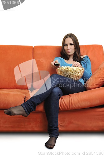 Image of young woman eat popcorn and watching tv