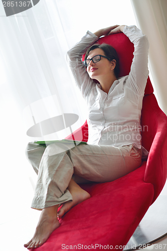 Image of woman using tablet pc at home
