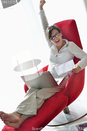 Image of woman using a laptop computer at home