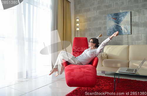 Image of happy young woman relax at home on sofa