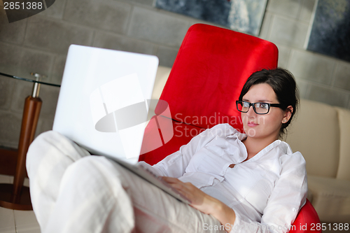 Image of woman using a laptop computer at home