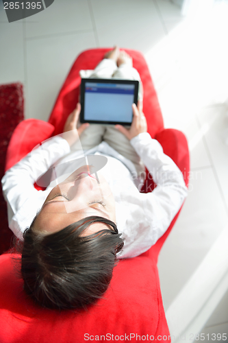 Image of woman using tablet pc at home