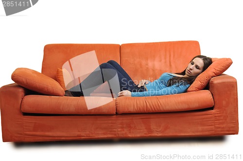 Image of happy young woman relax on orange sofa