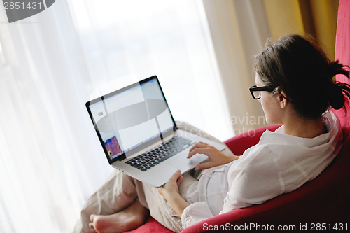 Image of woman using a laptop computer at home