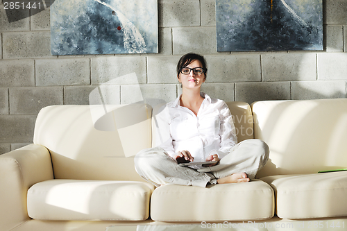Image of woman using tablet pc at home